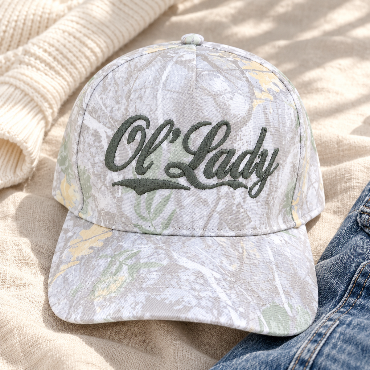 Ol’ Lady White Camo Embroidered Snapback Hat styled with ivory knit and denim