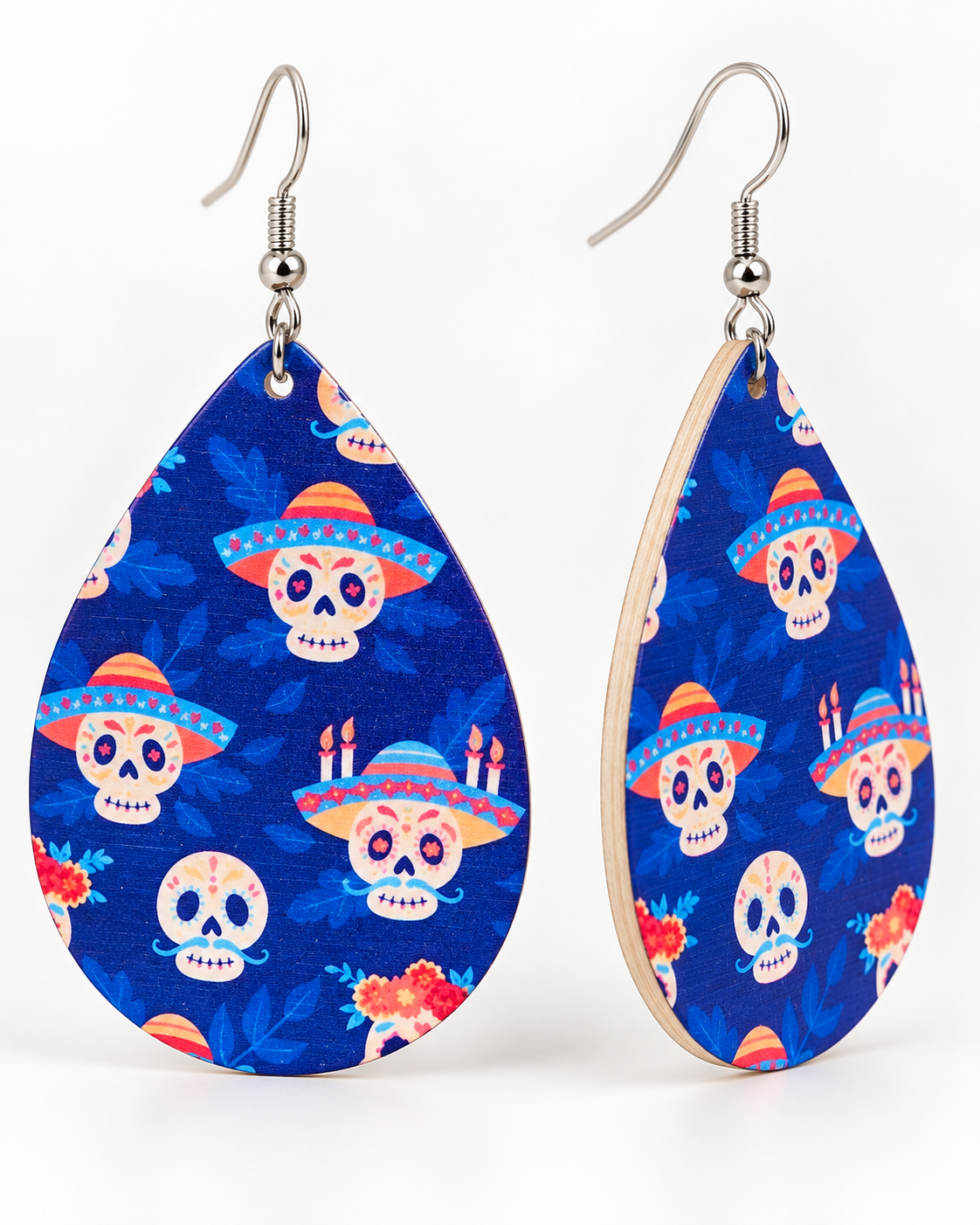 Angled view of blue sugar skull wood teardrop earrings with silver-tone fish-hook ear wires