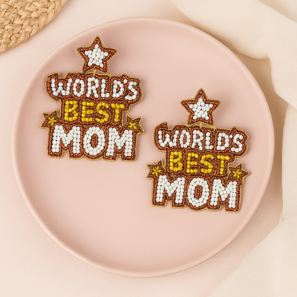 Two 'World's Best Mom' embroidered patches on a pink plate.