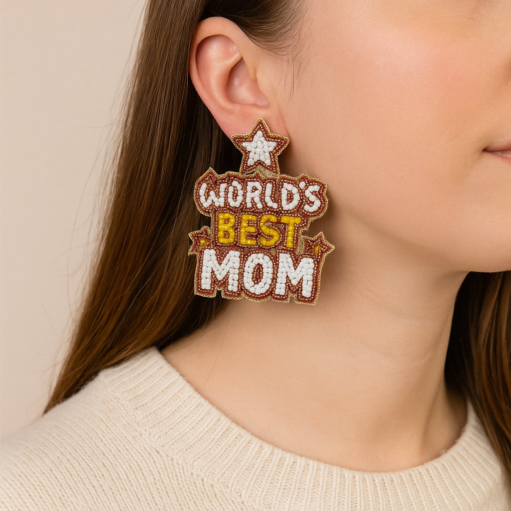 Earring with 'World's Best Mom' text worn by a person