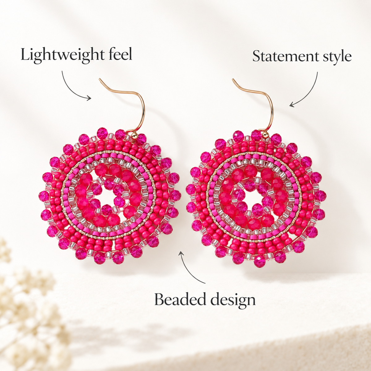A pair of bright pink beaded statement earrings with gold-tone hooks, displayed on a light cream background with decorative text overlays reading 'Lightweight feel', 'Statement style', and 'Beaded design'.