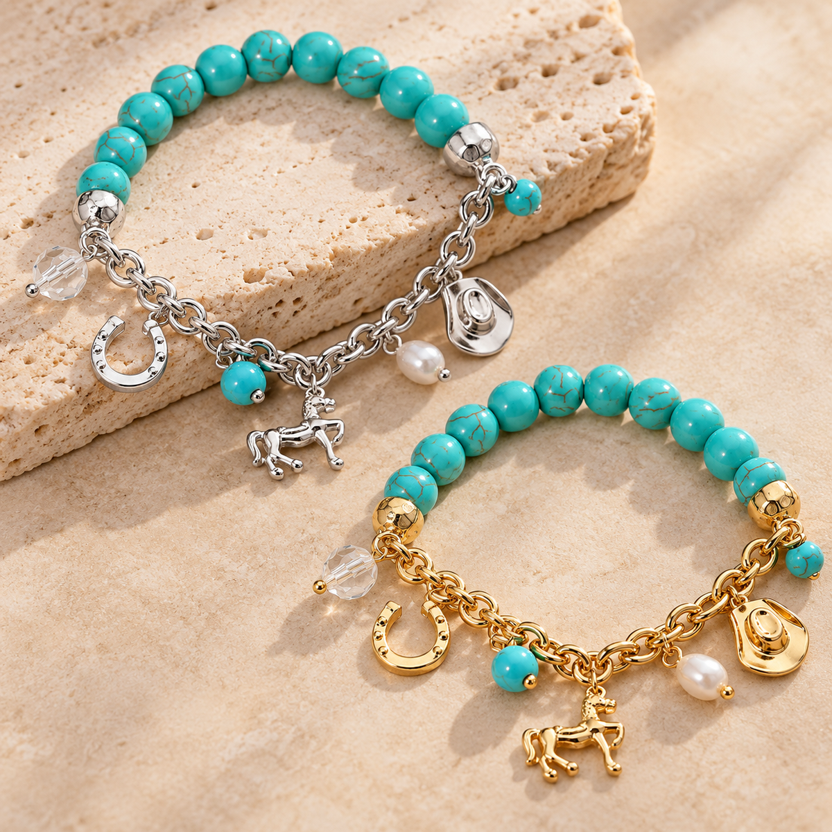 Two beaded charm bracelets with turquoise-blue beads, displayed on a beige textured surface. One bracelet has silver-tone chain and charms, and the other has gold-tone chain and charms.