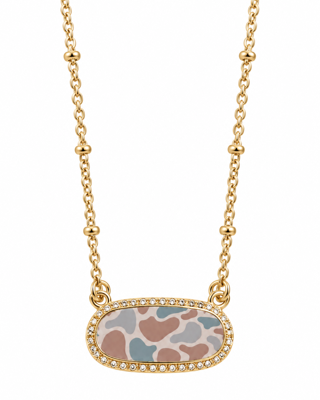 Gold beaded chain necklace with an oval pendant featuring a pastel animal print pattern in pink, blue, and beige, bordered with small clear rhinestones, on a white background.