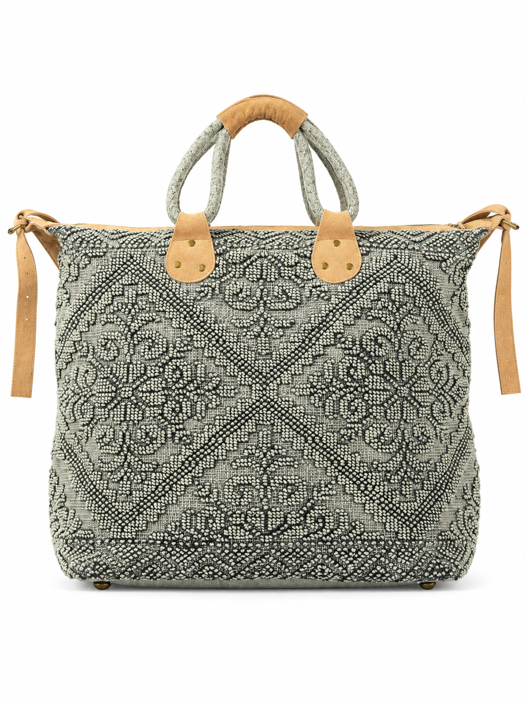 Black and ivory patterned tote bag featuring an intricate textured paisley design, tan leather accents, double wrapped handles, brass-tone hardware, and a detachable shoulder strap against a white background.
