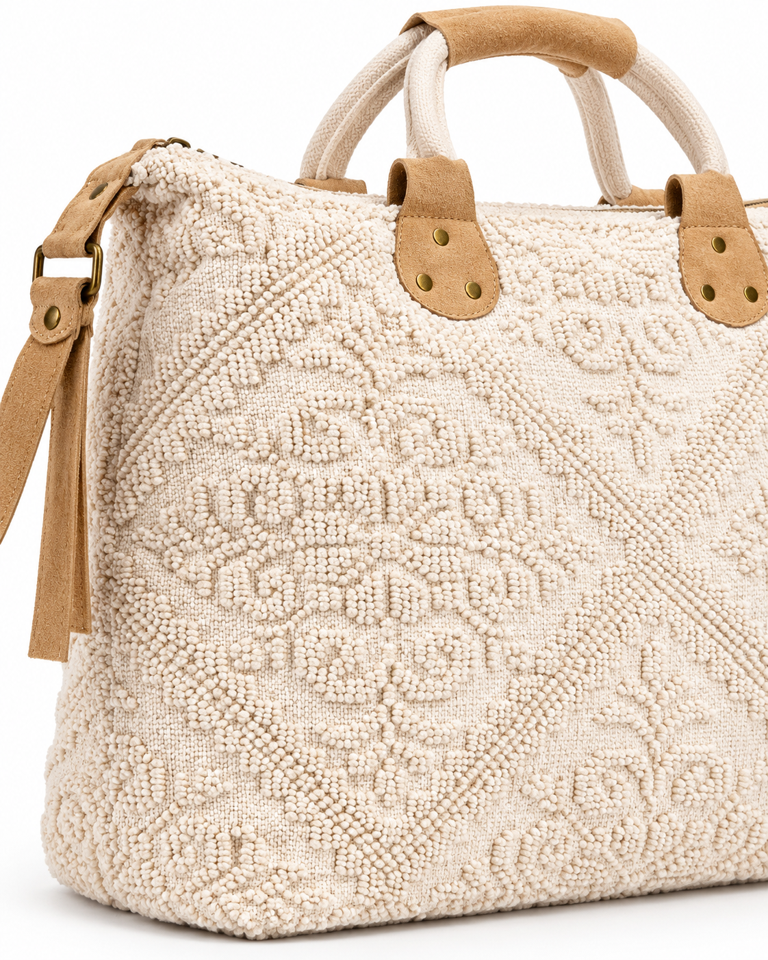 A close-up of a woven beige handbag with a textured geometric pattern, tan leather handle attachments, and cream rope handles on a white background.