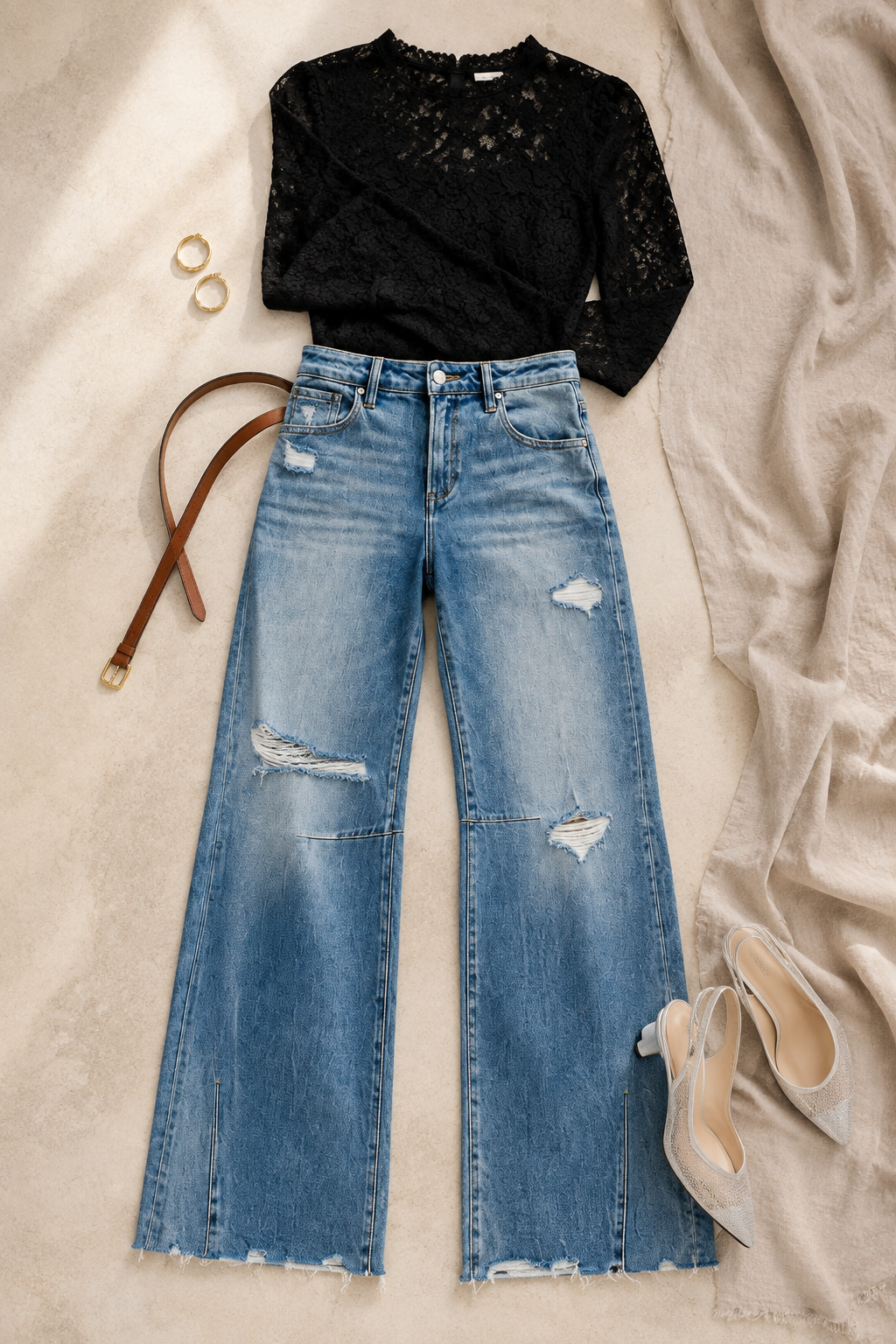 RISEN distressed wide-leg jeans styled with a black lace top, gold hoops and metallic heels