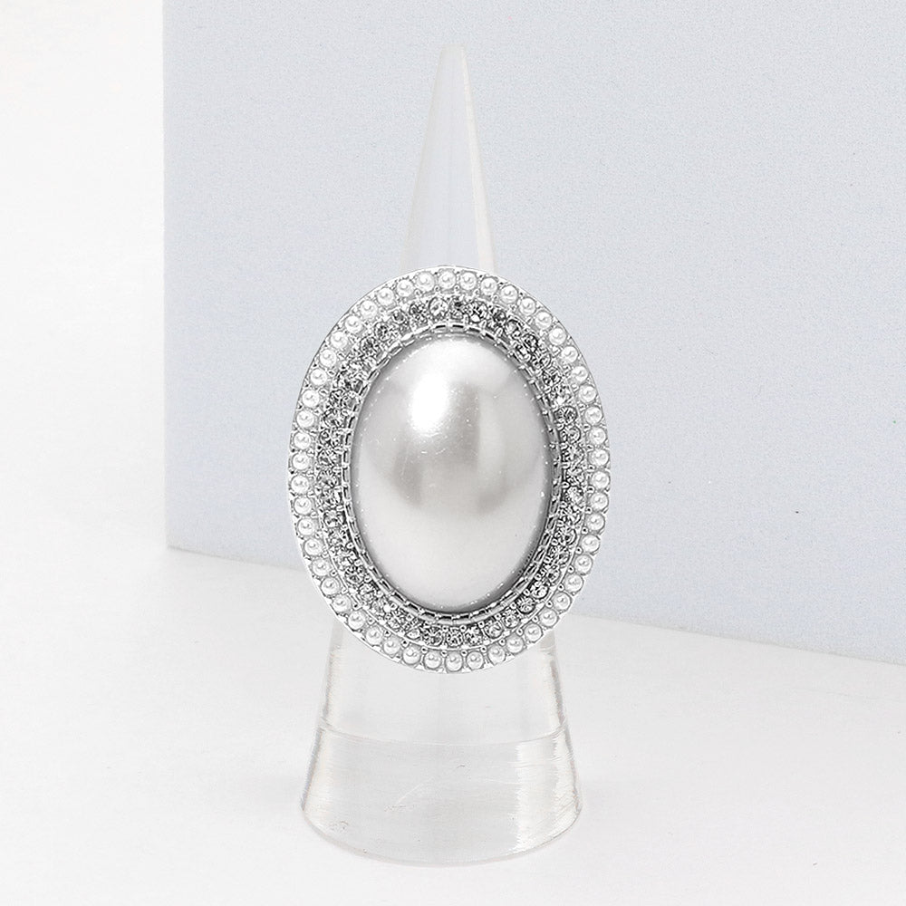 Pearl brooch with silver embellishments on a white background