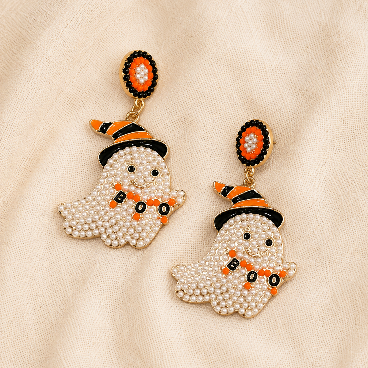 Close-up of pearl ghost BOO dangle earring with orange and black witch hat