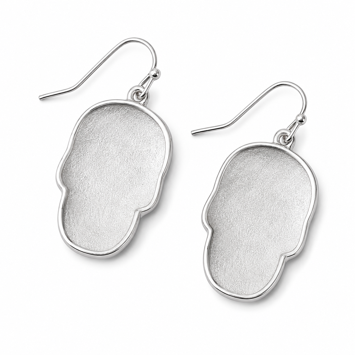 Back view of silver-tone skull earrings showing smooth metal backs and fishhook ear wires