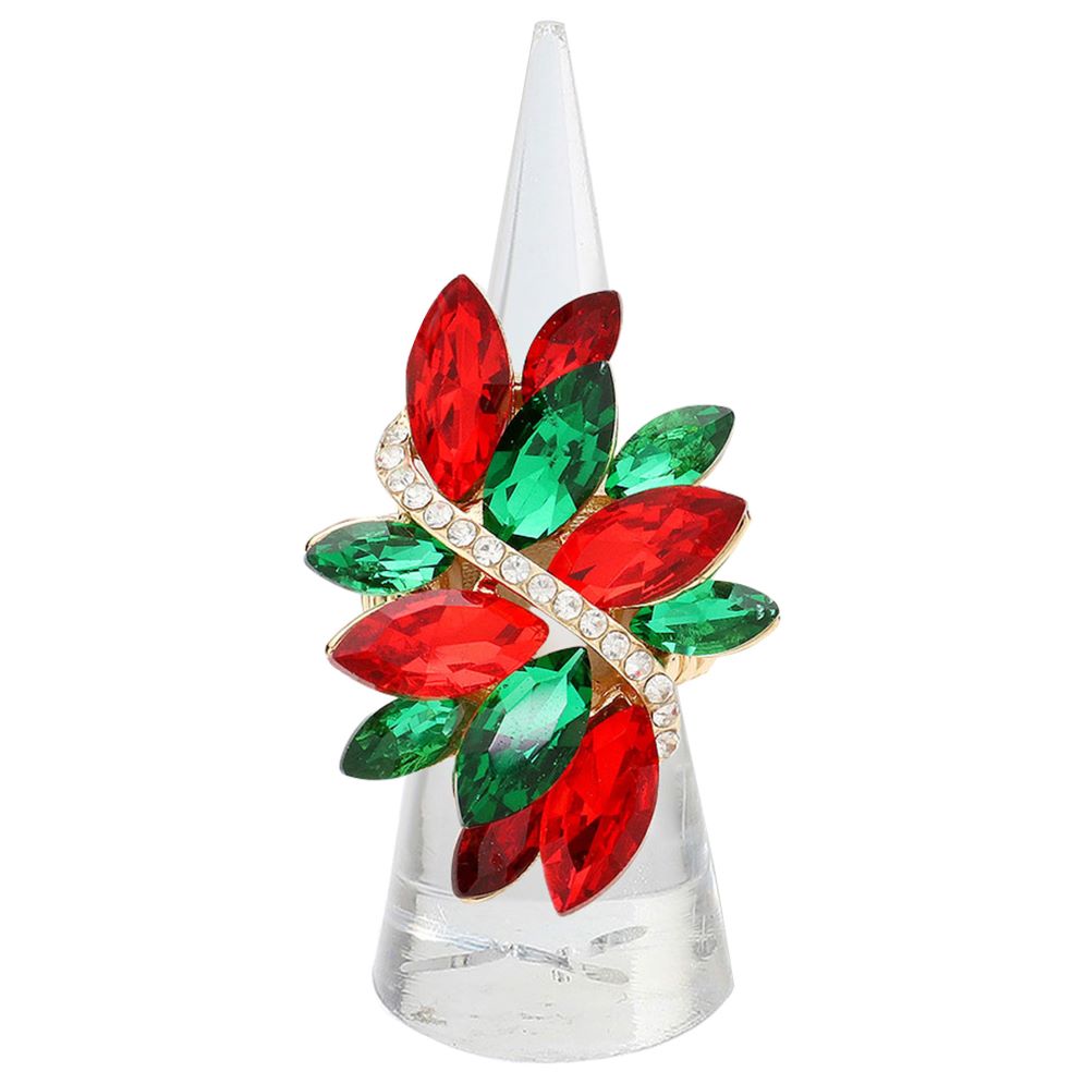 Decorative item with red and green gemstones on a clear base against a white background
