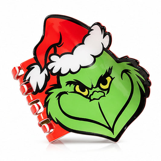 A novelty hair claw clip designed to look like the Grinch wearing a red Santa hat with white trim, set against a plain white background.