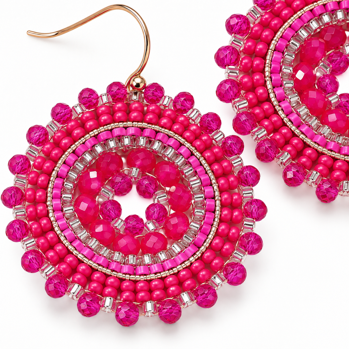 Bright pink beaded dangle earrings with faceted crystal details and rose gold fishhook wires, shown on a clean white background.