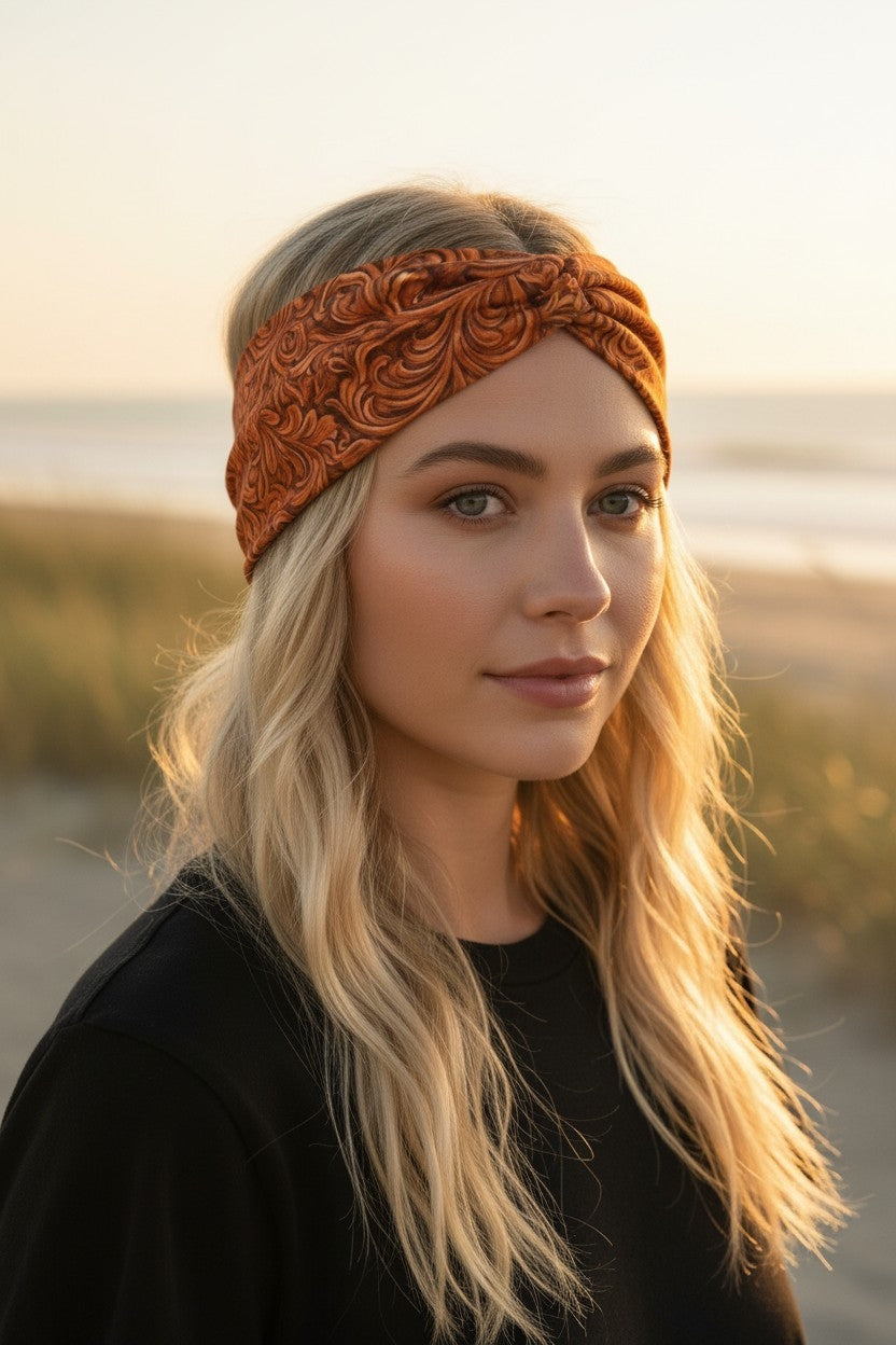 Woman wearing a decorative orange headband with a blurred natural background