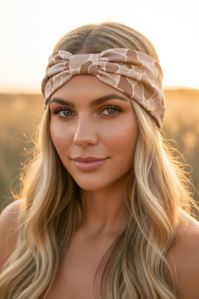 Woman wearing a beige headband with a blurred natural background