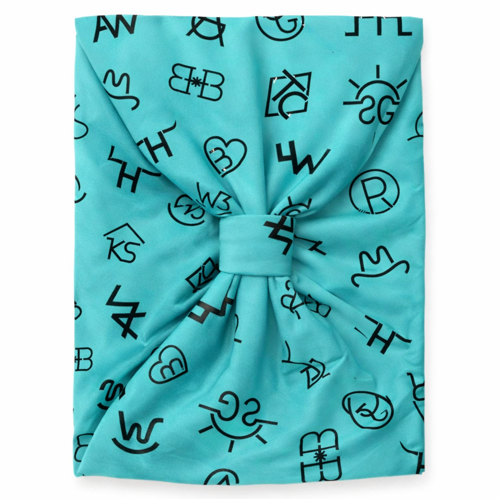 Turquoise headscarf with black abstract patterns on a white background