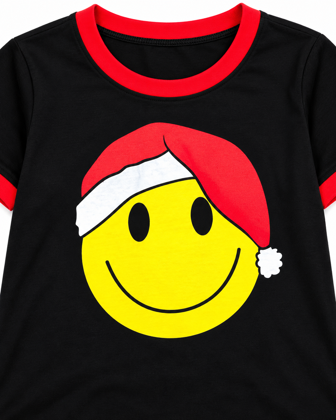 A close-up of a black ringer t-shirt with a red crew neck and sleeve trim, featuring a large yellow smiley face wearing a red Santa hat with a white brim and pom-pom on the front.