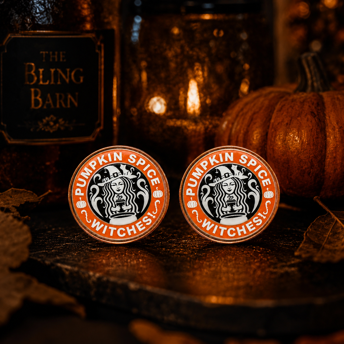 Pumpkin Spice Witches stud earrings photographed in a moody After Dark autumn scene with pumpkins.
