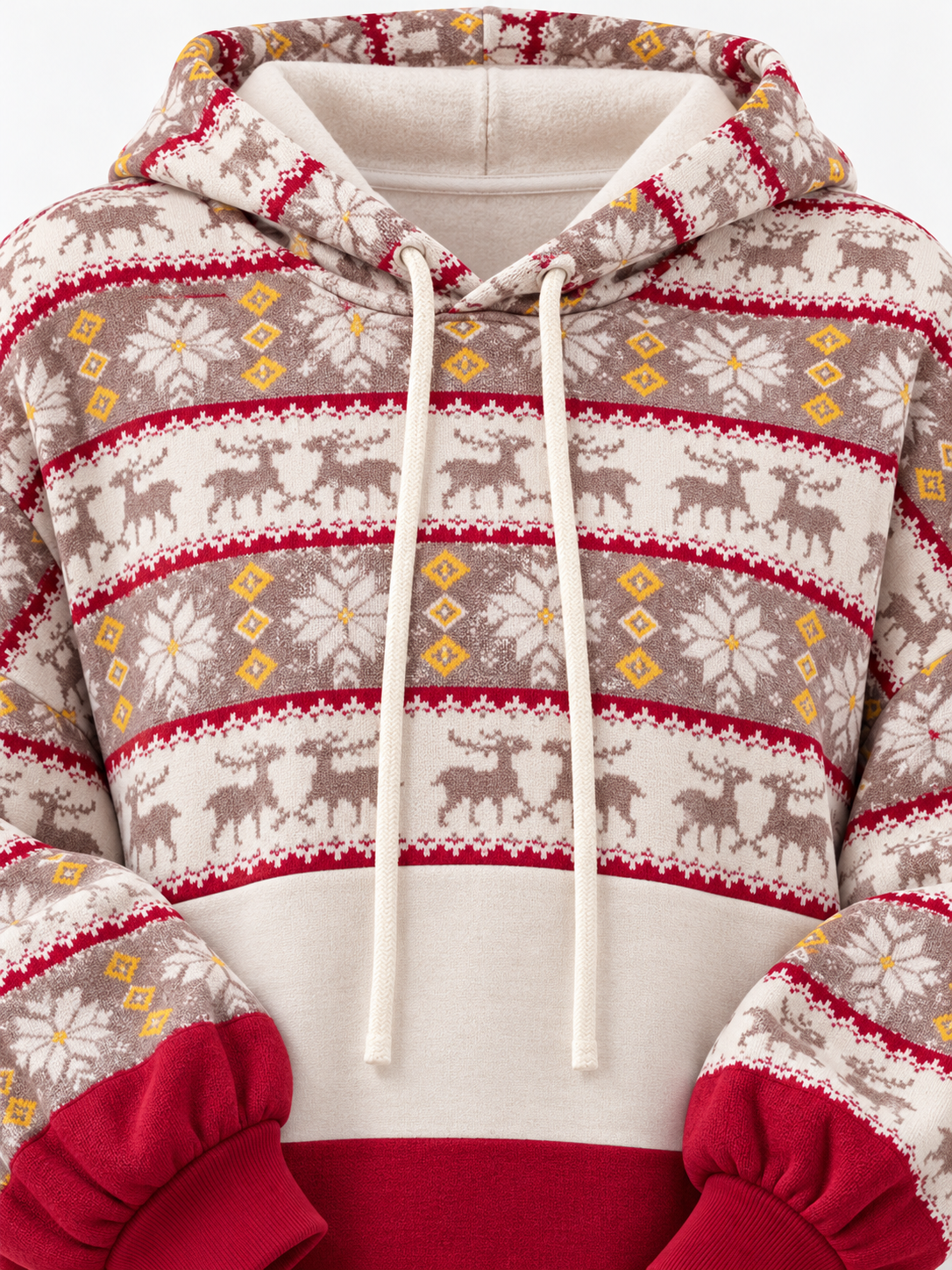 A close-up of a holiday-themed pullover hoodie featuring a cream base with horizontal bands of brown reindeer, red geometric borders, and yellow floral motifs. The hoodie has a solid red lower section and white drawstrings.