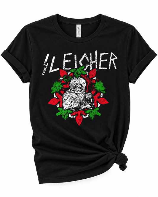 A black short-sleeve graphic t-shirt with a distressed white 'SLEICHER' text print and a Santa Claus design in red and green, styled with a knot at the bottom hem on a white background.
