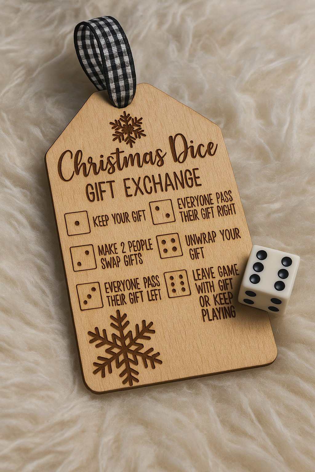 Wooden tag with Christmas dice gift exchange rules and a die on a soft surface